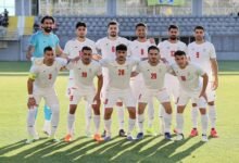 Iran players pose for a team group photo before the match