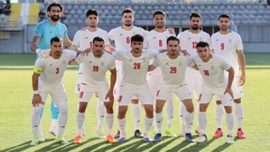 Iran players pose for a team group photo before the match