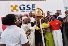 Dr. Adjei, (third from left), Mrs. Ofosu-Adjare, (second from righ), and Ms. Amoah, (right) tolling the GSE listing bell to officially admit Kasapreko PLC