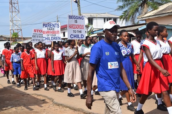 The children displaying placards as their walk through the principal streets of La
