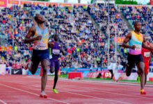 Letsile Tebogo crossing the finish line ahead of Gout Gout during the men's 200m