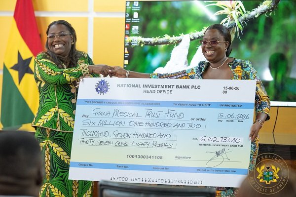 Nana Oye Bampo Addo, (left) presenting the dummy cheque to Ms Darko-Opoku