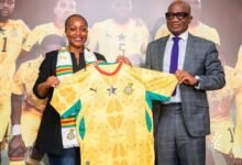 Madam Ndanyungu receives a signed Black Stars jersey from Mr Addo
