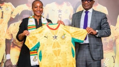 Madam Ndanyungu receives a signed Black Stars jersey from Mr Addo