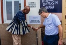 Mr. Thomas (right) and a representative from Ga Mantse Palace jointly turn on the tap during the inauguration ceremony