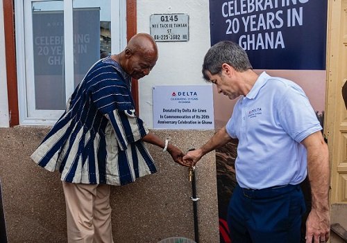 Mr. Thomas (right) and a representative from Ga Mantse Palace jointly turn on the tap during the inauguration ceremony