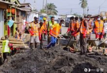 The filth from the drains being cleared off the street