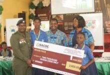 Lt. Col. Safo Boye, (left), presenting the overall prize to students of Kotoka Basic School, Burma Camp, Accra. Photo Ebo Gorman