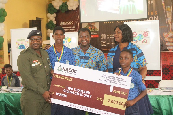 Lt. Col. Safo Boye, (left), presenting the overall prize to students of Kotoka Basic School, Burma Camp, Accra. Photo Ebo Gorman