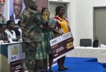 Brigadier General Mantey presenting the overall prize award to students of Accra Girls Senior High School