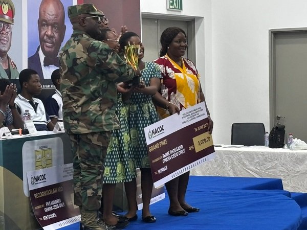 Brigadier General Mantey presenting the overall prize award to students of Accra Girls Senior High School