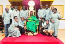 Osagyefuo Amoatia Ofori Panin II (seating in state) with Professor Ofori (standing, fourth from right) and the rest of the delegation from the university