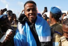 Omar Artan is draped in a Somali flag upon his arrival in the capital, Mogadishu