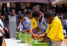 Pupils in a water bottle filling competition
