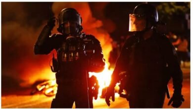 Police officers on a Paris street during fan unrest after PSG won the UEFA Champions League on Saturday