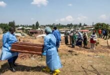 Red Cross workers prepare to bury an Ebola victim
