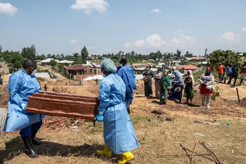 Red Cross workers prepare to bury an Ebola victim