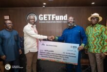 Saka Homes backs GETFund -----Mr Addo-Mensah (second from right) presenting the dummy cheque to Mr Adjei