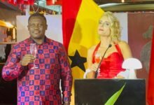 Mr George (left) with Mrs Giger proposing a toast at the 735th National Day celebration programme