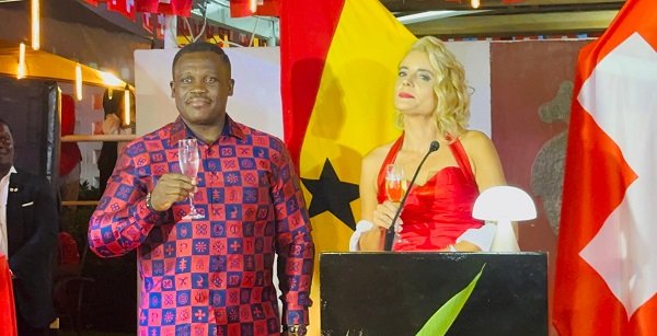 Mr George (left) with Mrs Giger proposing a toast at the 735th National Day celebration programme