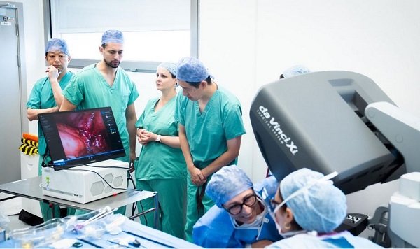 Surgeons look at a screen displaying an AI overlay of patient anatomy during the operation