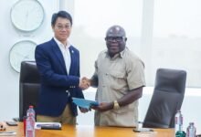 Mr Li (left) and Mr Ashie exchanging greetings after signing the Agreement