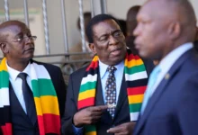 President Emmerson Mnangagwa, center, stands next to his chief election agent and Justice Minister Ziyambi Ziyambi left