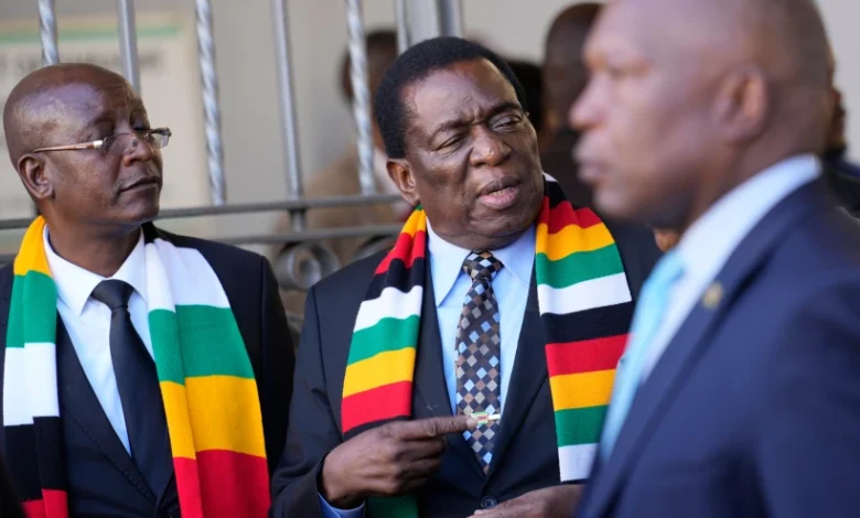 President Emmerson Mnangagwa, center, stands next to his chief election agent and Justice Minister Ziyambi Ziyambi left