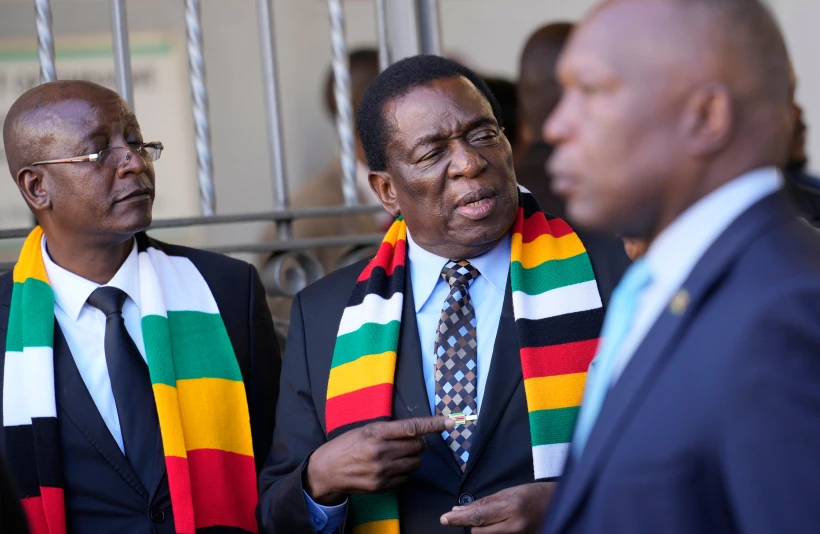 President Emmerson Mnangagwa, center, stands next to his chief election agent and Justice Minister Ziyambi Ziyambi left
