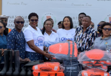Ms Kaleo-Bioh,(third from left) Head, Business and Commercial Banking, Stanbic Bank presenting the relief items to Mr. Alalzuuga Albert Akuka, Deputy Director General in Charge of Livelihoods and Migration, NADMO