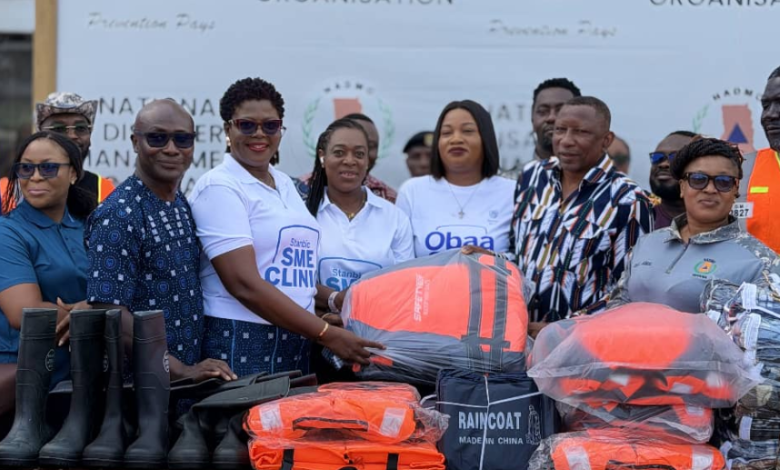 Ms Kaleo-Bioh,(third from left) Head, Business and Commercial Banking, Stanbic Bank presenting the relief items to Mr. Alalzuuga Albert Akuka, Deputy Director General in Charge of Livelihoods and Migration, NADMO