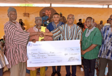 Mr Asomaning (second from right) presenting the cheque to representatives of the Yaa Naa