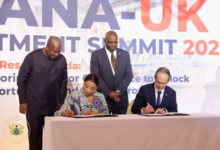 Mrs Sabah Zita Benson (seated left) and Mr. Christian Rogg, British High Commissioner to Ghana signing the MoU. With them is President Mahama (standing left)