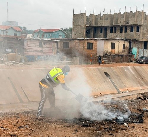 A resident burning refuse collected during the cleanup exercise