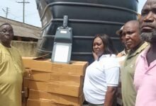 Ms Sowah (third from right) handing over the streetlight, polythank and one of the footbridges