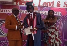 Dr Norman presenting a certificate to one of the graduates. With them is Ms Adzanu