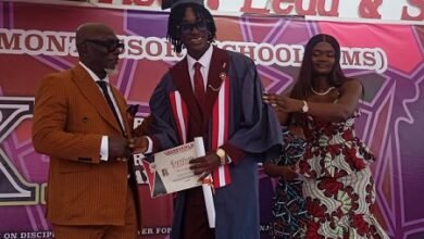 Dr Norman presenting a certificate to one of the graduates. With them is Ms Adzanu