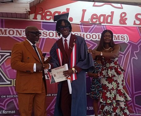 Dr Norman presenting a certificate to one of the graduates. With them is Ms Adzanu