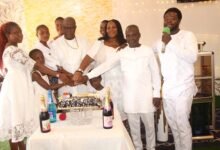Apostle Eric Botchwey (third from left) and wife jointly cutting the birthday cake during the sunday church service