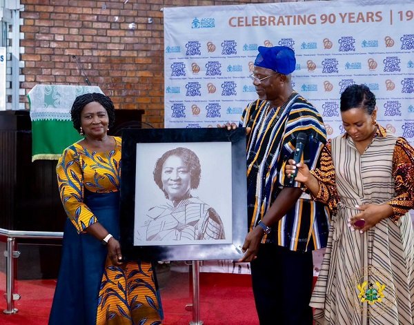 Vice President Jane Naana Opoku-Agyemang, (left) receiving a photograph of herself at the anniversary