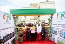 Mrs Awatey (middle) cutting the tape to open the expo