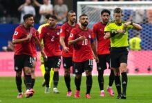 Egyptian players led by Mohamed Salah confronts referee François Letexier during the game