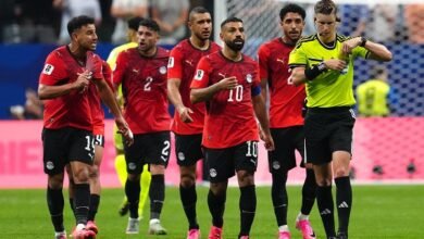 Egyptian players led by Mohamed Salah confronts referee François Letexier during the game
