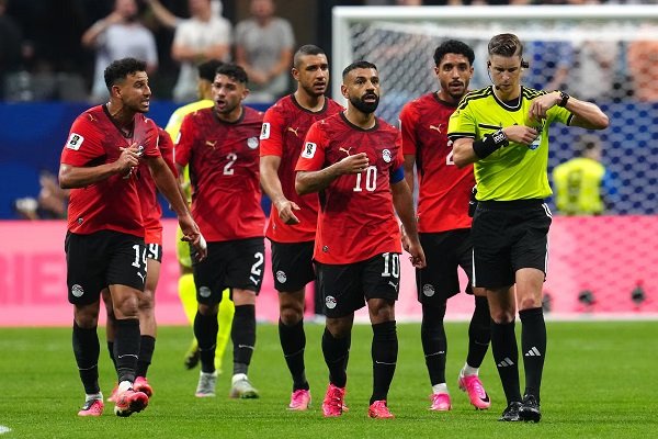 Egyptian players led by Mohamed Salah confronts referee François Letexier during the game