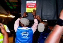 An FDA official affixing a closure notice to one of the affected premises during the enforcement operation