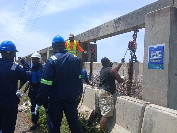 Some technical men working on the Havedzi floodgate