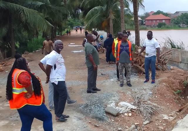Mr Ashiagbor (right) and other memebers of the assembly inspecting construction works on the spillage