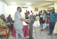 Mr Dwumfour (standing) addressing the media. Photo Victor A. Buxton