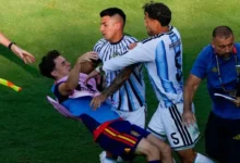 Gavi, (left) falls as he scuffles with Leandro Paredes