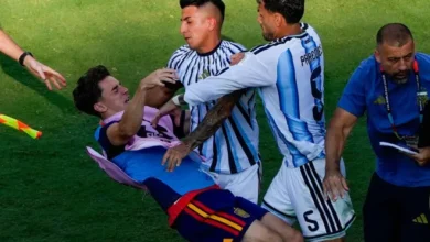 Gavi, (left) falls as he scuffles with Leandro Paredes